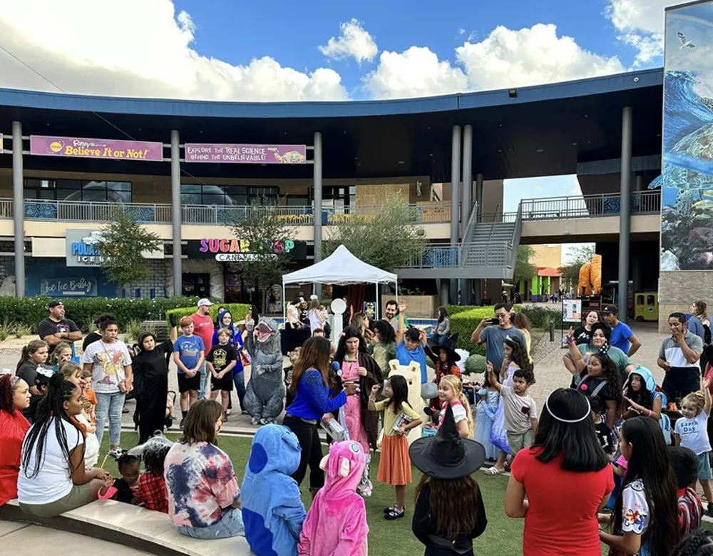 Families gathered in costume at a publisher-hosted community event